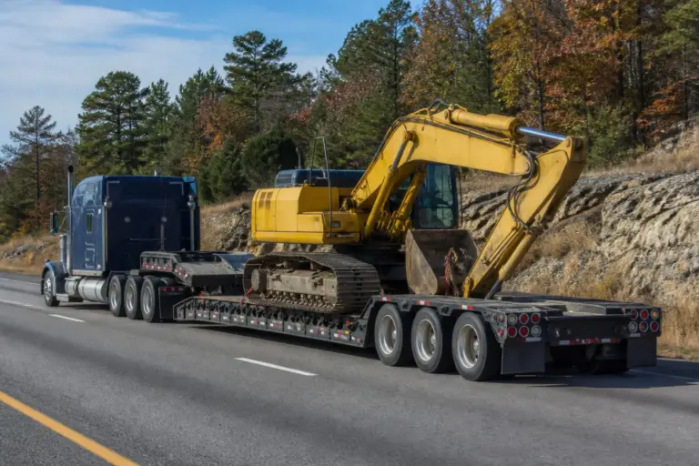 RGN lowboy trailer hauling an excavator for a superload permit