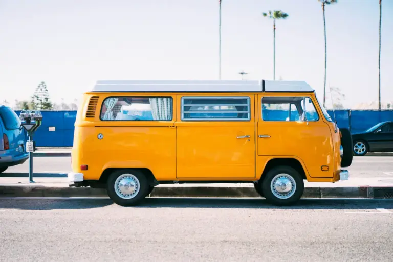 Yellow van parked roadside, shown with the oversize load travel restrictions article